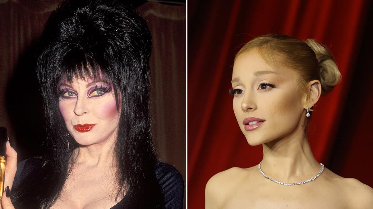 Elvira dengan rambut hitam besar, gaun hitam dan riasan tampak di sebelah kanannya di atas karpet dalam balutan gaun strapless dengan Ariana Grande membelah kirinya.